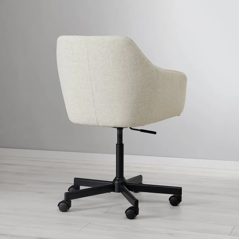 Modern adjustable office chair with soft padding and black castors on light wood floor.