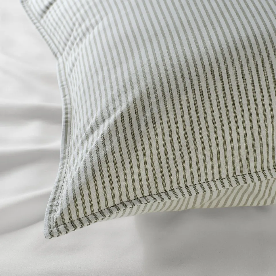 Close-up of a striped pillow with crisp stitching, showcasing high-quality cotton texture and craftsmanship.