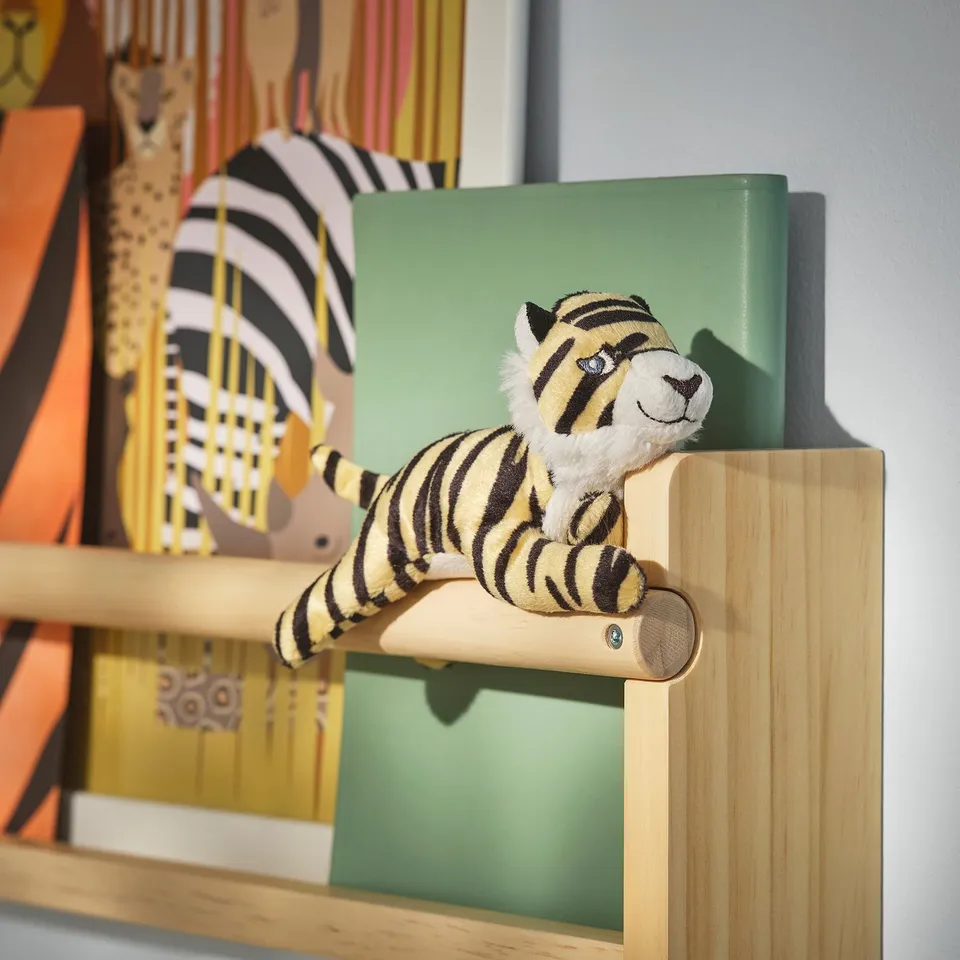Soft tiger toy from DJUNGELSKOG, small, striped, sitting on wooden shelf, black & yellow, recycled polyester.