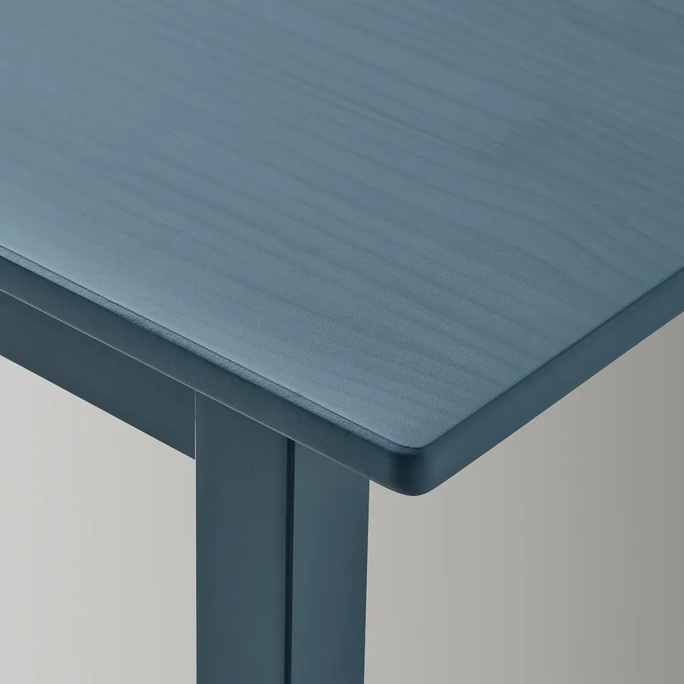 Dark blue childrens table with smooth, rounded edges and visible wood grain texture.