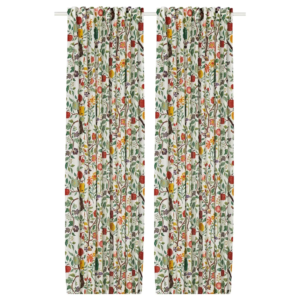 Two colourful floral curtains hang side by side, featuring lush greens, reds, and yellows on a white background, crafted from cotton and ramie.