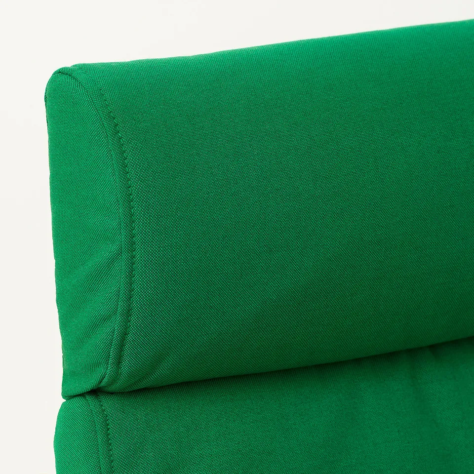 Close-up of a vivid green fabric, likely from a high-quality sofa or chair, showcasing its smooth texture and neat stitching.