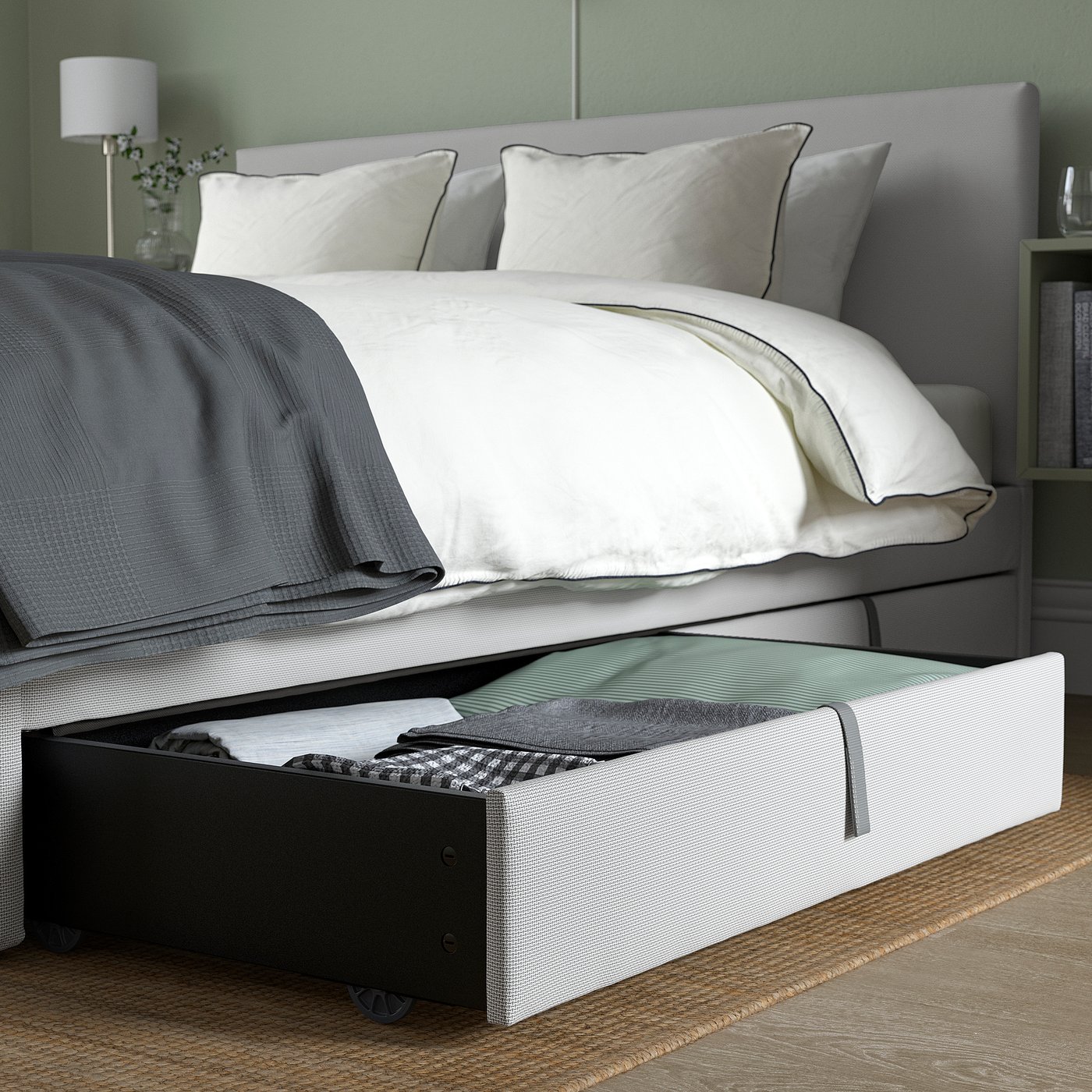 Bed with open storage box under, showing practical under-bed storage with fabric drawers.