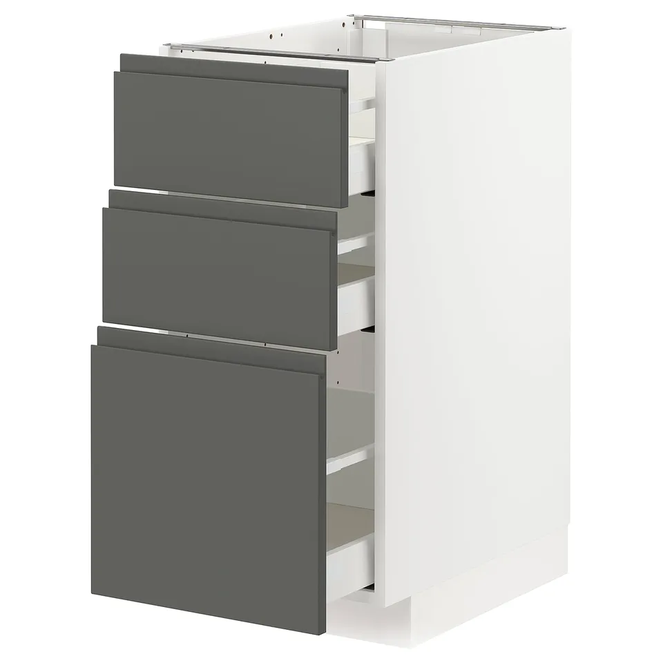 A modern white METOD kitchen cabinet with dark grey drawers, sleek and integrated handles. Its designed for a contemporary and calming look.