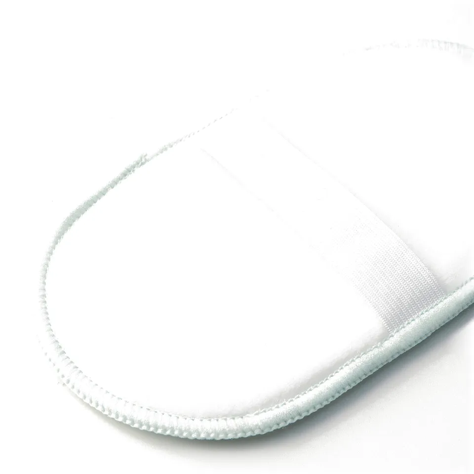 Round white microfibre pad, quality stitching visible along edge, laid flat on white surface.