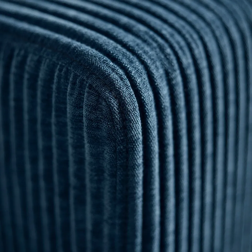 Close-up of deep blue JÄTTEBO sofa, showing plush, textured fabric and fine details.