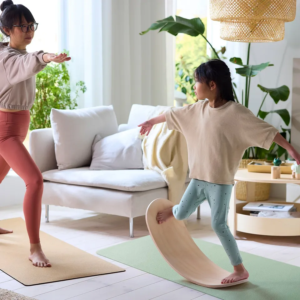 Balance boards in living room; child practises, adult guides. Or, even shorter: balance boards; child practises, adult guides.