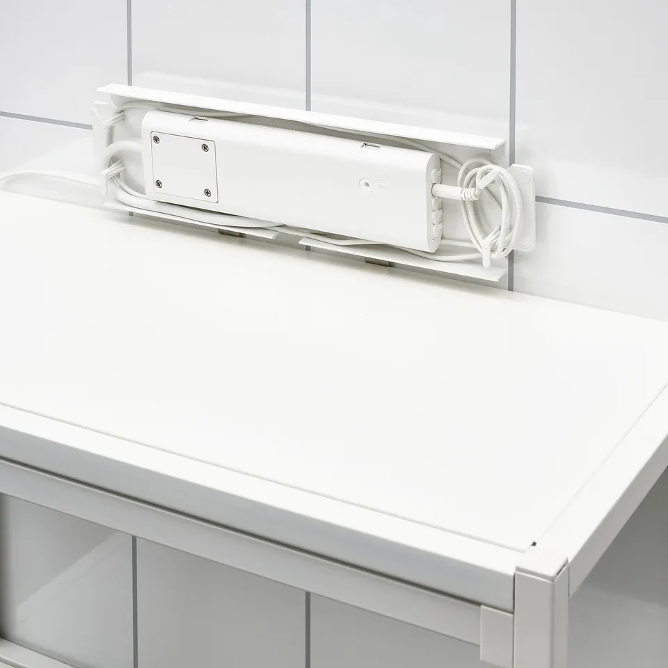 White rectangular device attached to a wall, with cables and a small label. Its an ikea SILVERGLANS led driver for smart lighting control.