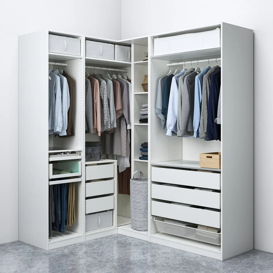 White corner wardrobe, PAX series, organises clothes and accessories with shelves, drawers, and hanging space.