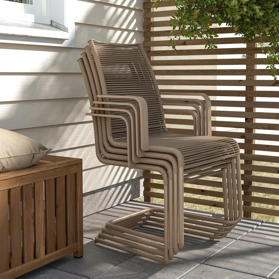 Stack of 4 wicker patio chairs on a wooden deck, suitable for outdoor seating.