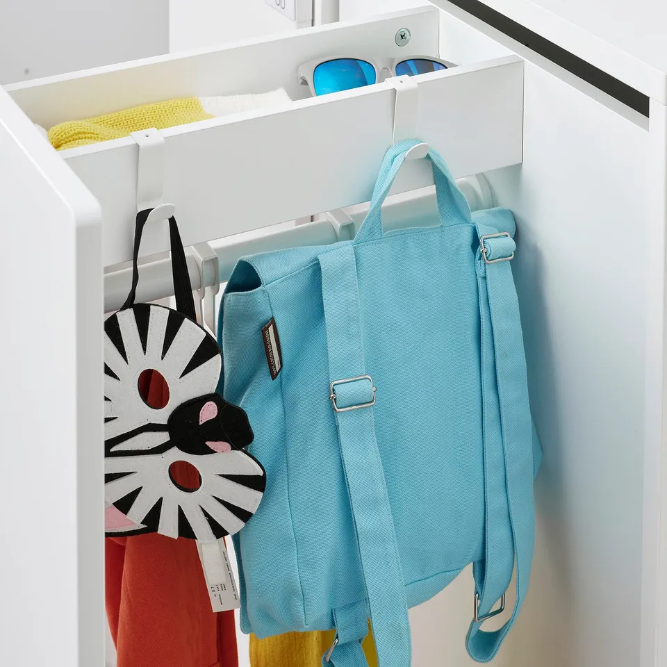 A light blue backpack hangs on a white LÄTTHET hook in a wardrobe, showcasing its practical storage solution.