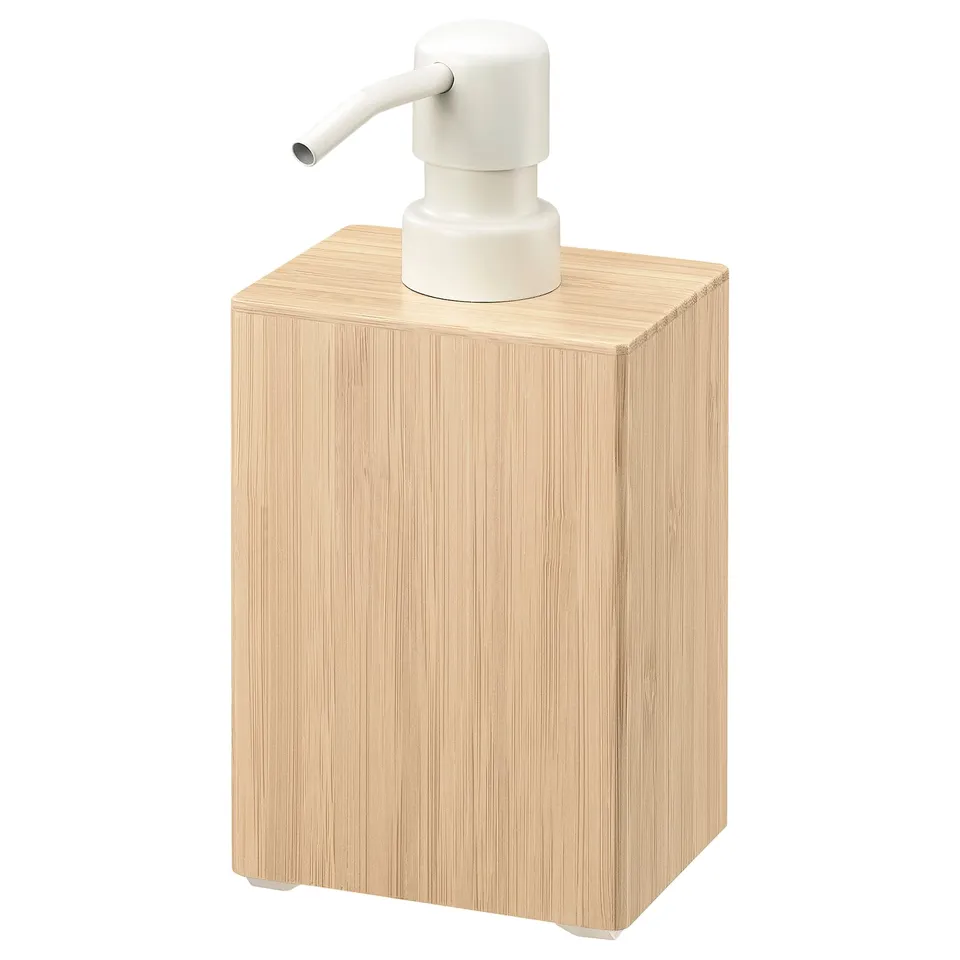 A white STEGESUND soap dispenser with a bamboo base. The dispenser has a sleek, modern design and is rectangular in shape with rounded edges.
