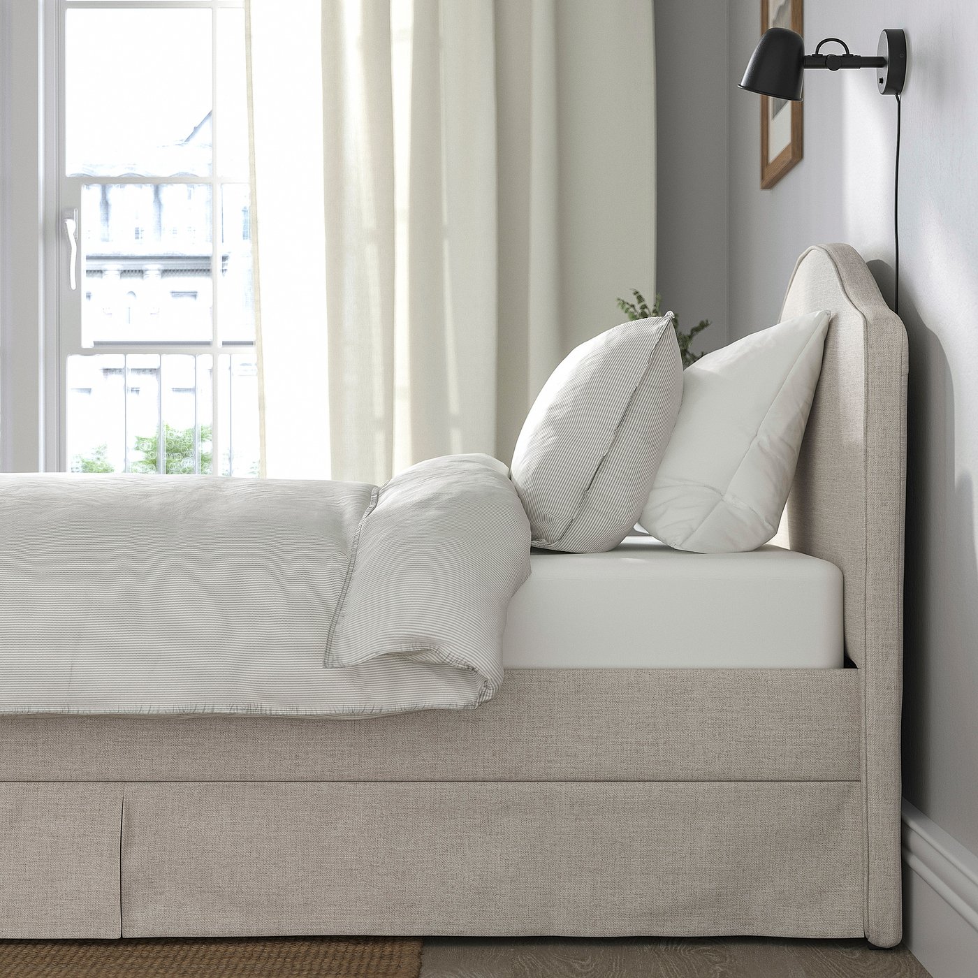 Modern bed with curved headboard and piped edges. Soft, padded headboard ideal for reading or watching tv.