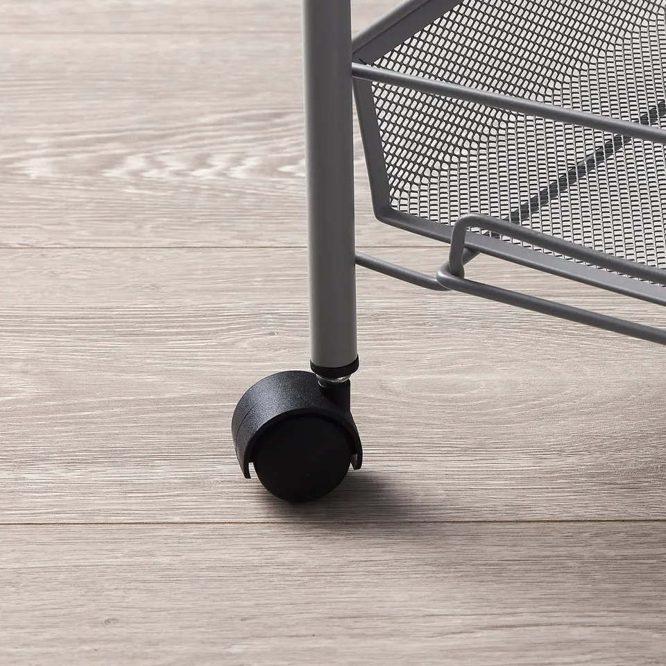Black trolley on wheels, part of a grey storage unit, designed for easy movement.