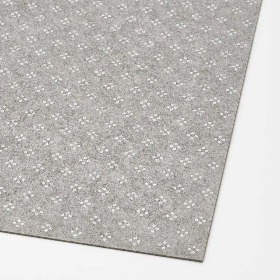 A grey drawer mat with small white dots, designed to prevent sliding and protect surfaces.