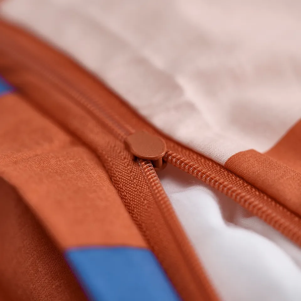 Close-up of rust-colored zip on fabric bag.