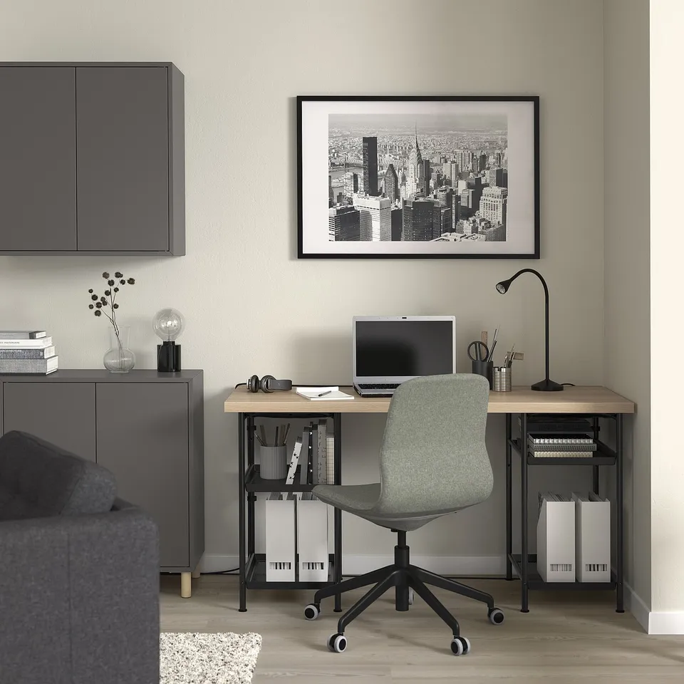 Home office with LAGKAPTEN desk, chair, lamp, and storage. Cityscape art, computer on desk.