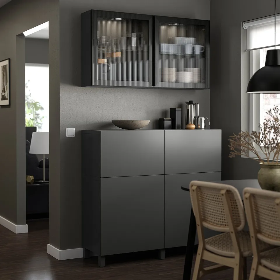Modern kitchen with LAPPVIKEN grey cabinet, glass-door cabinet, wicker chairs, and pendant lamp.