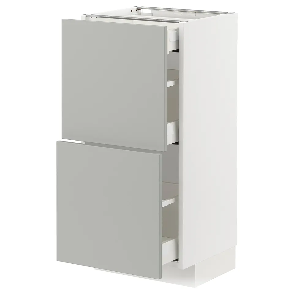 This image shows a white and light grey ikea METOD kitchen cabinet with two drawers and a door in a minimalist design with a clean look.