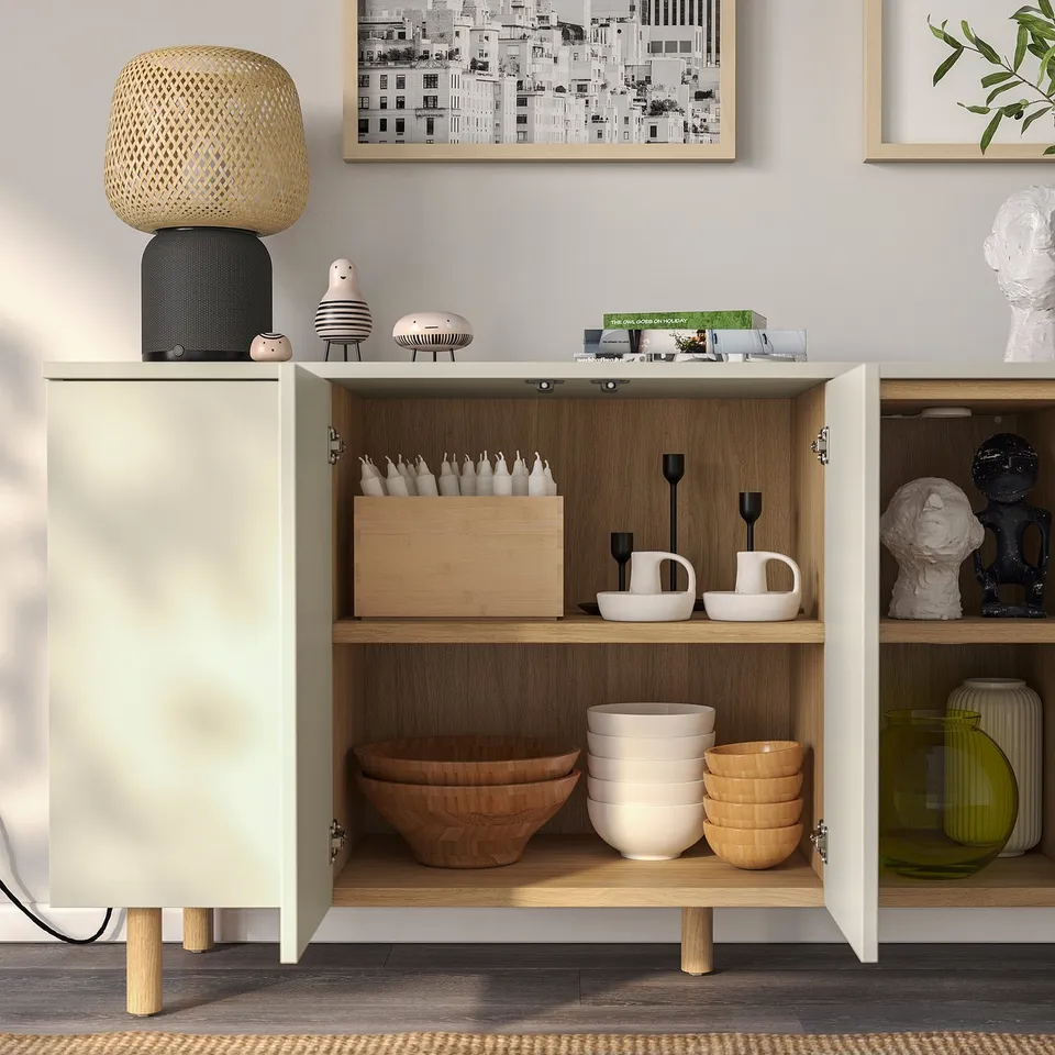 Modern cabinet with open shelves, showcasing bowls, candles, and decorative items. Push-open doors and adjustable shelves.
