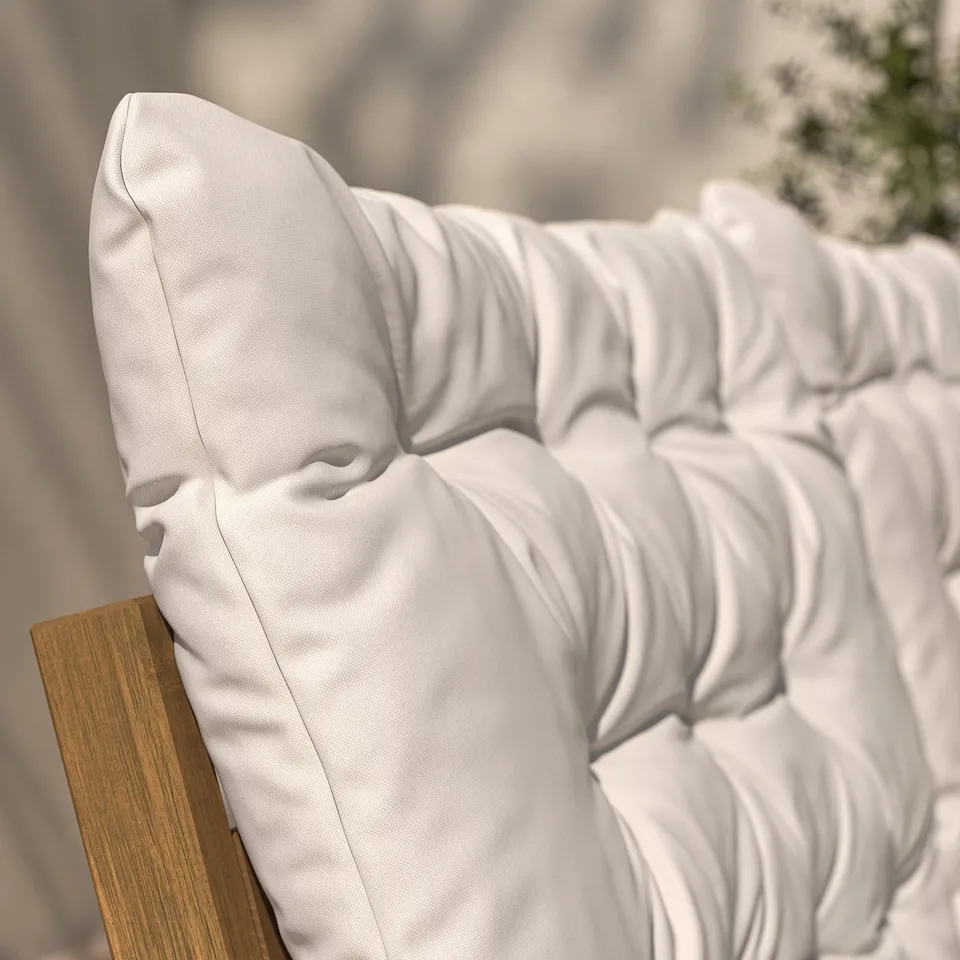White cushion on wooden outdoor furniture, showcasing premium texture and comfort.
