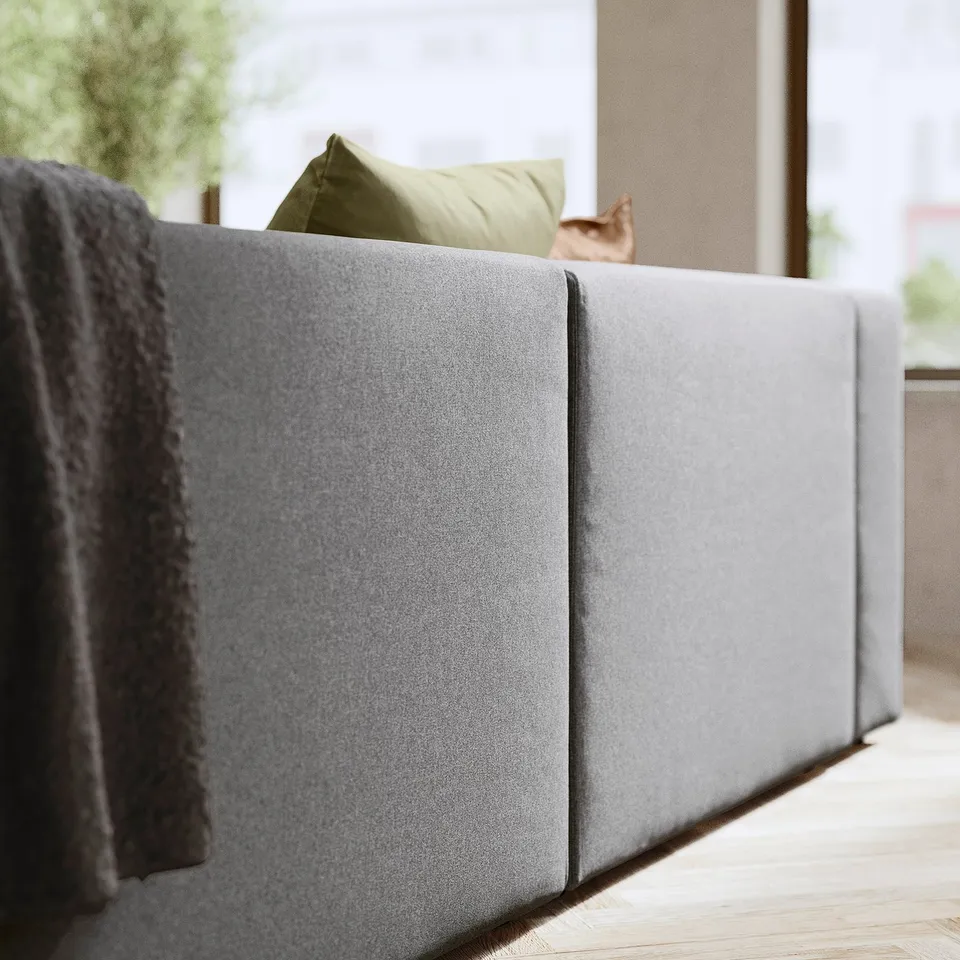 Grey JÄTTEBO sofa, modern design with soft cushions and storage, pet resting.