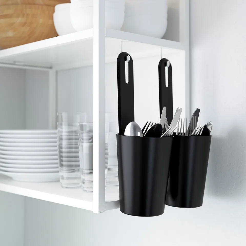 Black hooks hold kitchen utensils inside cabinet, maximising storage space.
