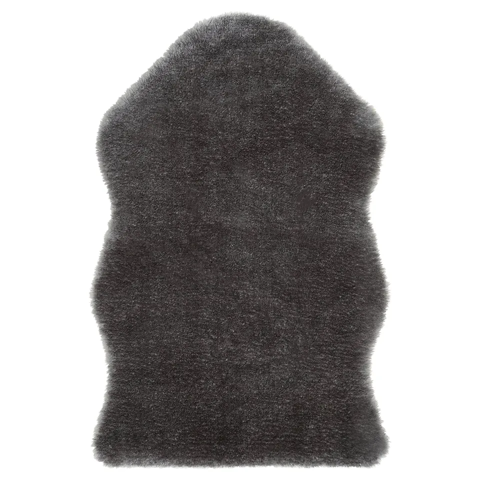 A TOFTLUND faux sheepskin rug in dark grey, rectangular, soft, and textured, made from recycled polyester.