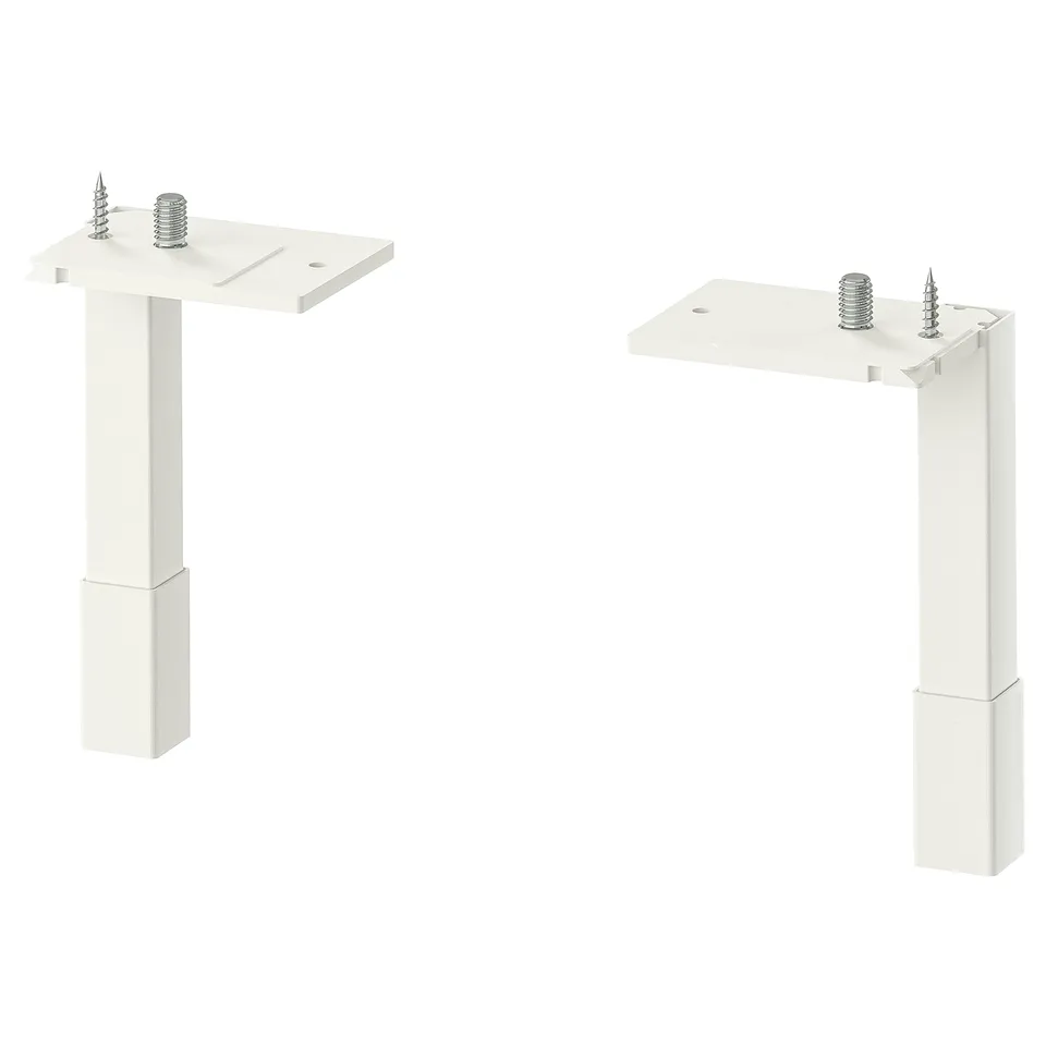 Two white metal ENHET cabinet legs, each with adjustable screws, standing upright. Simple, minimalist design for stability and airy look.