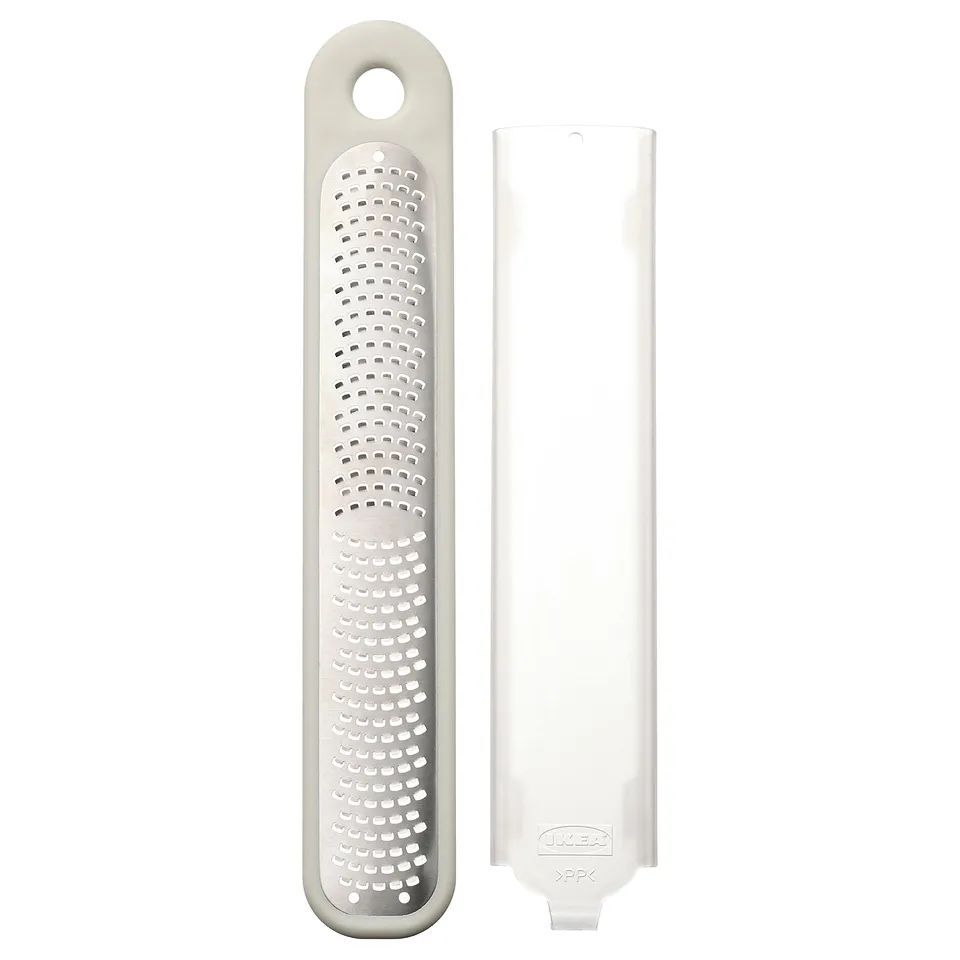 UPPFYLLD handheld grater, white, plastic protector, stainless steel grater, rectangular shape, compact design.