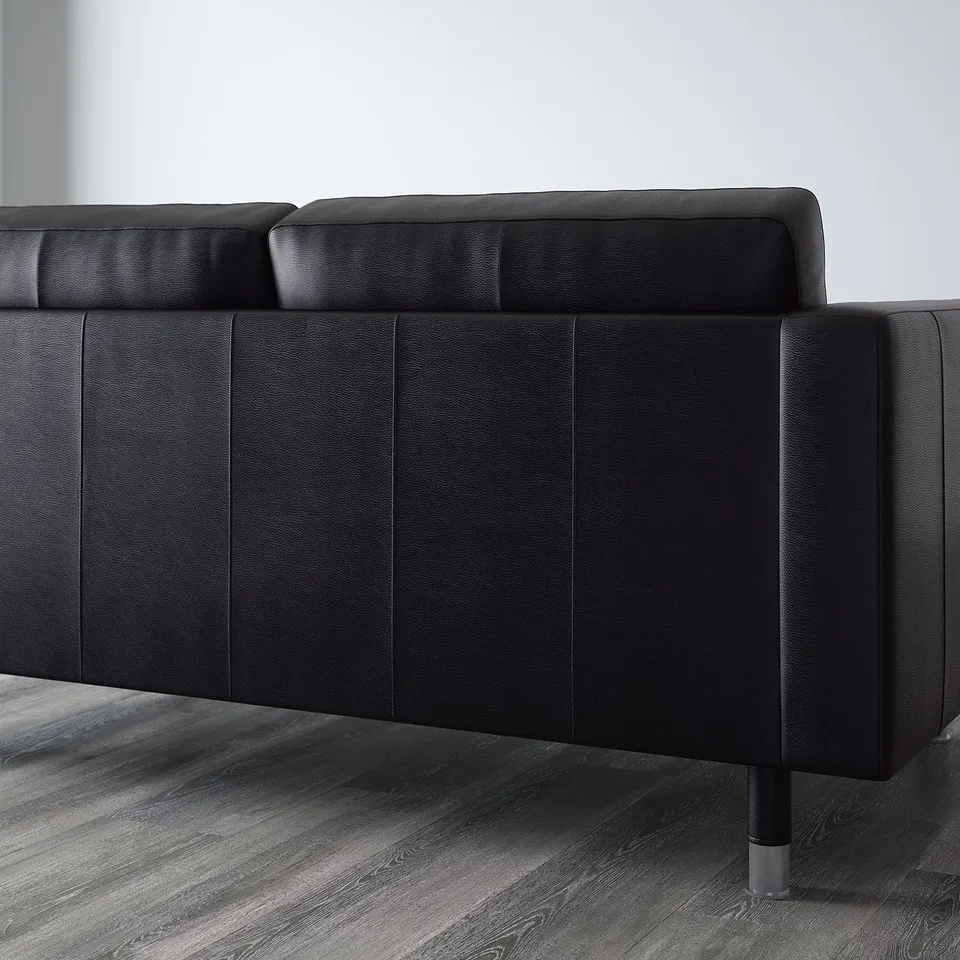 Black leather sofa with clean lines and metal legs, part of landskröna series, known for comfort and durability.