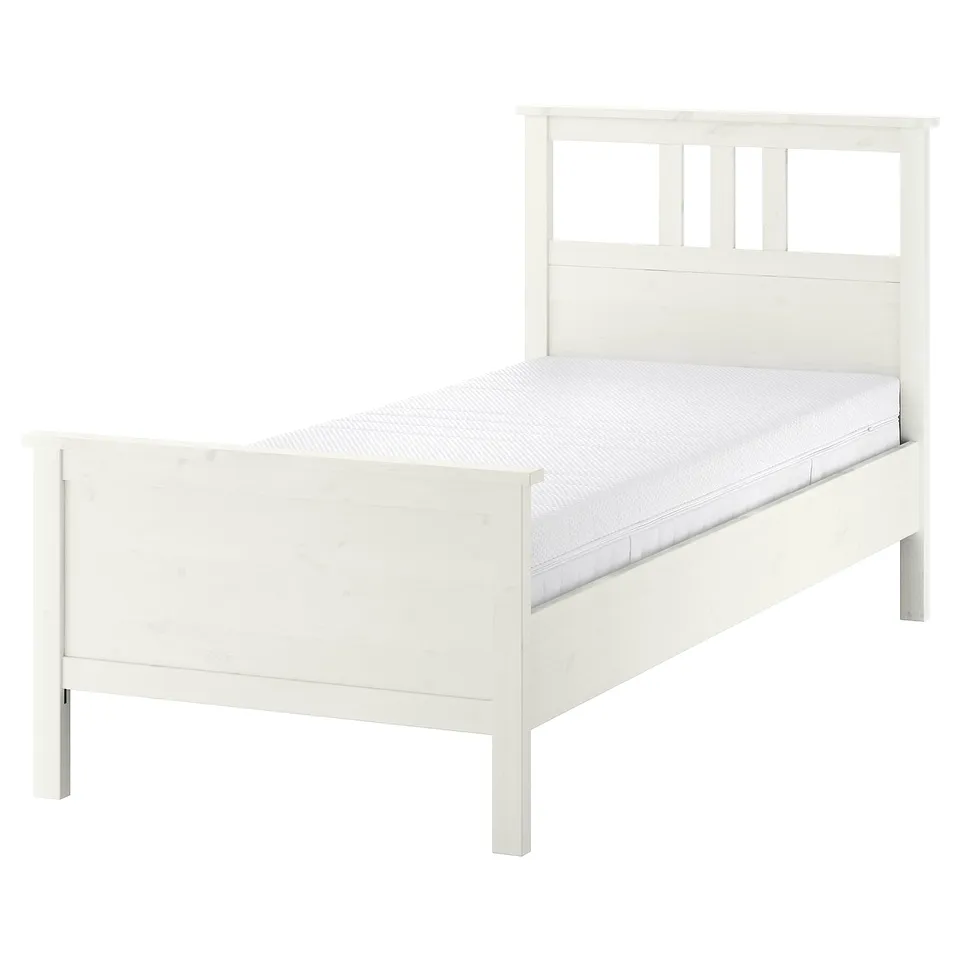 White HEMNES solid wood bed with adjustable sides and memory foam mattress.
