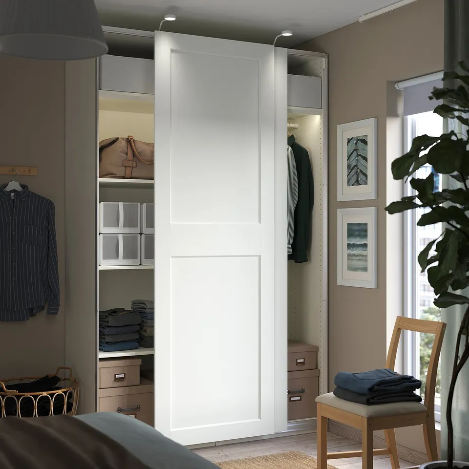Modern, white, built-in closet with sliding doors; sleek, minimalist design.