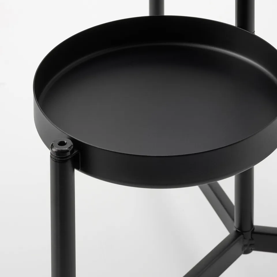 Black metal plant stand with round tray shelf, sturdy design, suitable for indoor/outdoor plants.