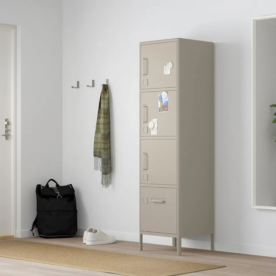 IDÅSEN storage cabinet in beige, tall, metal, fits next to door, holds various items, has hooks and magnets.