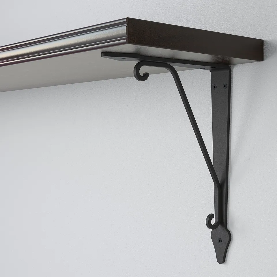 Black metal bracket securely supports dark wood shelf against light wall. Robust design ensures stability.