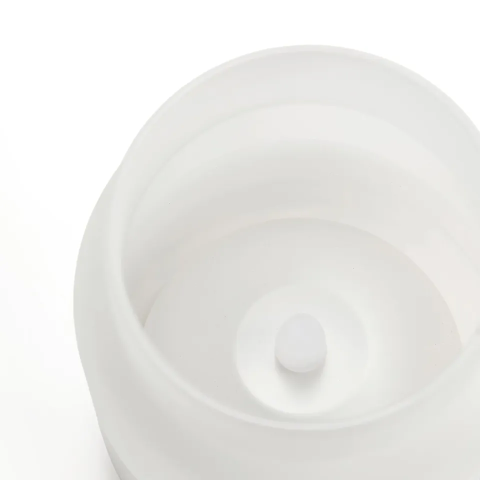 Round, frosted glass candle holder with smooth surface and elegant design.