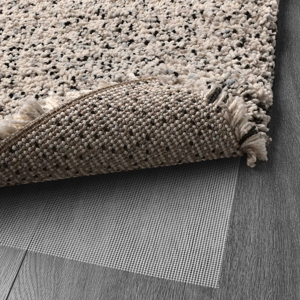 Net rug underlay keeps the rug in place, preventing slips and making cleaning easier; suitable for all floor types.