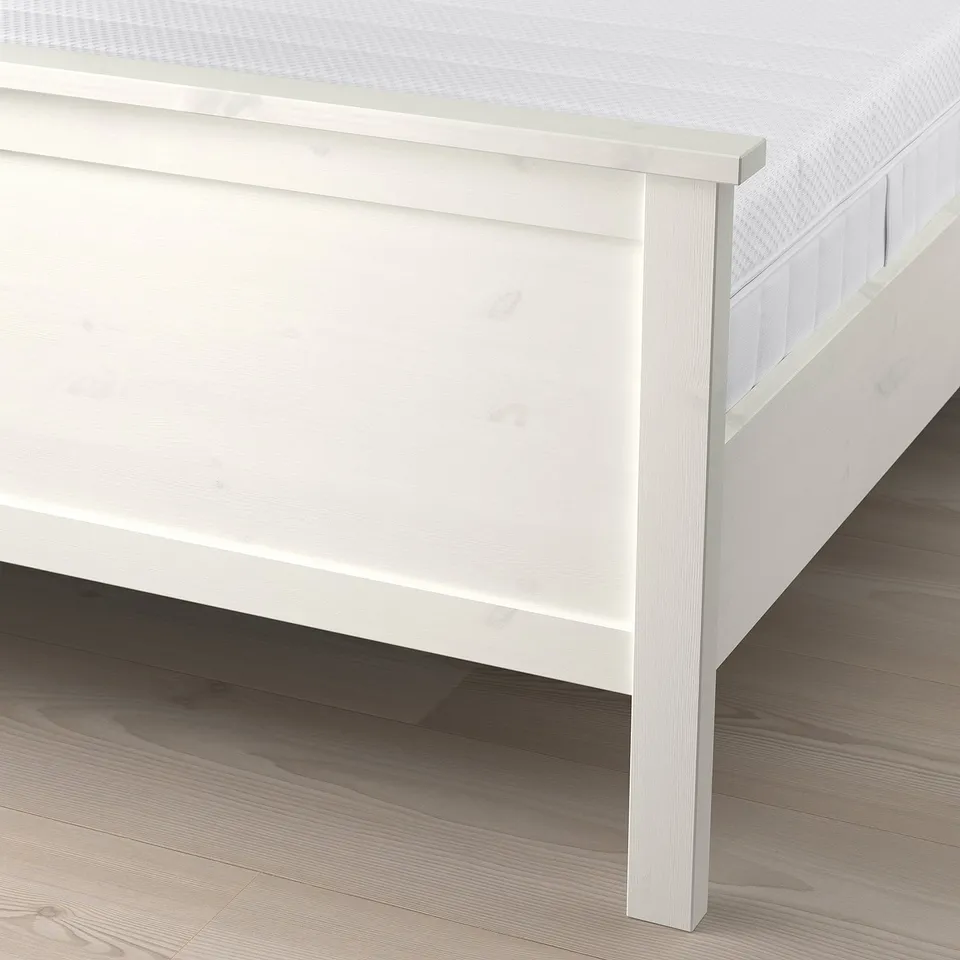 White HEMNES bed frame with adjustable slats and high headboard.