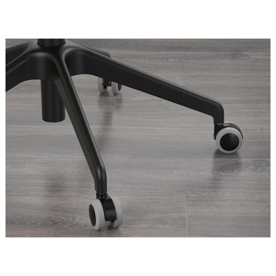Close-up of an office chairs sturdy base and smooth-rolling wheels on a wooden floor.