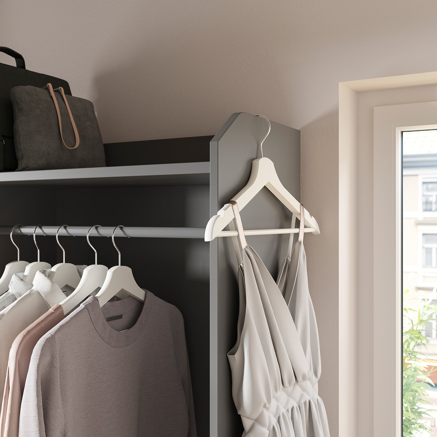 Modern closet with grey fabric drawers, white hangers, light grey dress, and white walls. A bag and black coat hang at the top.