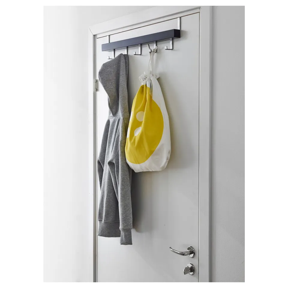 Grey TJUSIG coat hanger with hooks on door, holding grey hoodie and yellow bag.