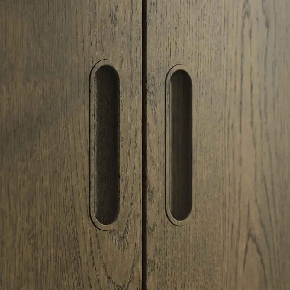 Wooden cabinet with two dark horizontally grooved handles.