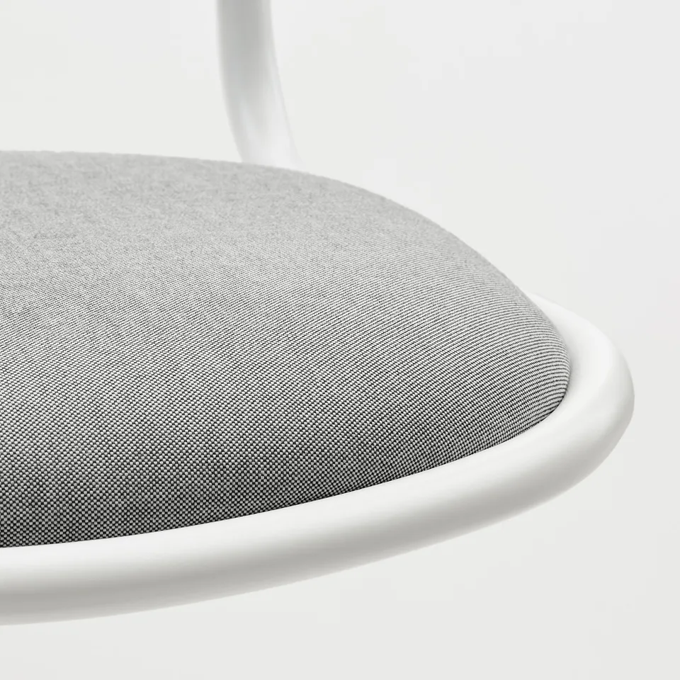 Close-up of modern chair edge, soft fabric, sleek metal frame.