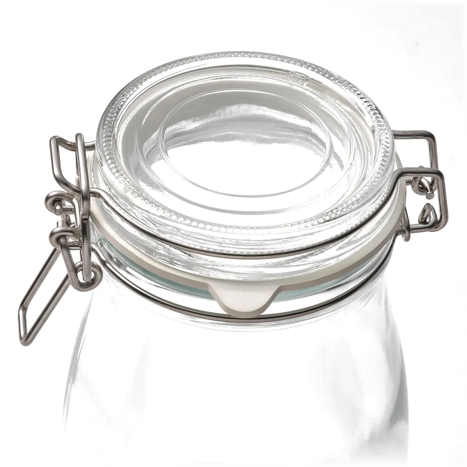 Empty glass jar with metal clasp lid, sealed airtight for preserving.
