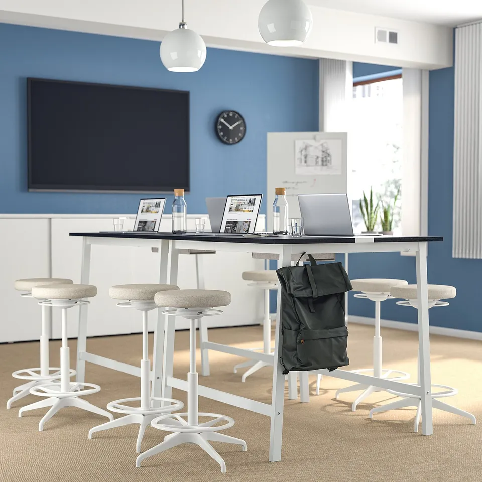 Modern office with MITTZON table, laptops, natural light.