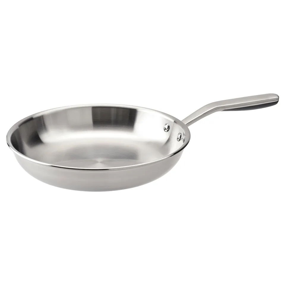 A SENSUELL stainless steel frying pan. It has a sleek, silver design with a long, ergonomic handle. The pan is round with a flat, thick base.