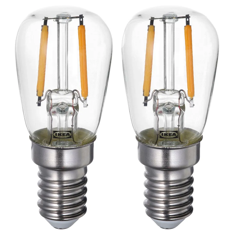 Two ikea LUNNOM light bulbs, clear glass with silver base, vintage design with yellow filaments.