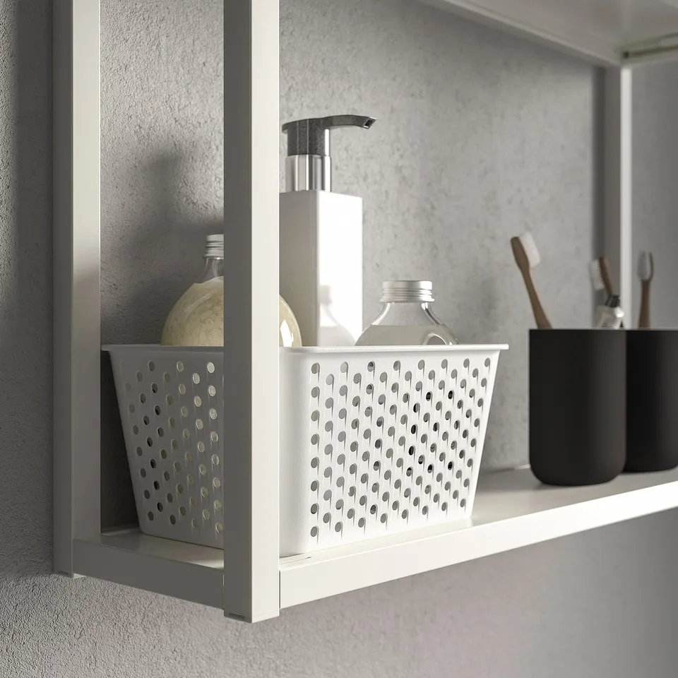 A bathroom shelf with storage baskets holding toiletries, featuring a soap dispenser and toothbrush holder.