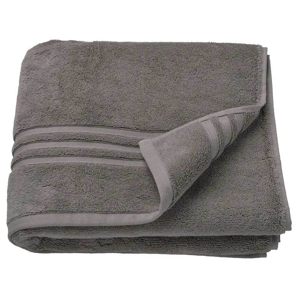 Grey BROKGLIM organic cotton towel, folded with woven border detail.